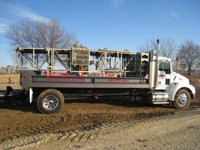 Kenworth flatbed loaded with Neubauer Masonry scaffolding systems